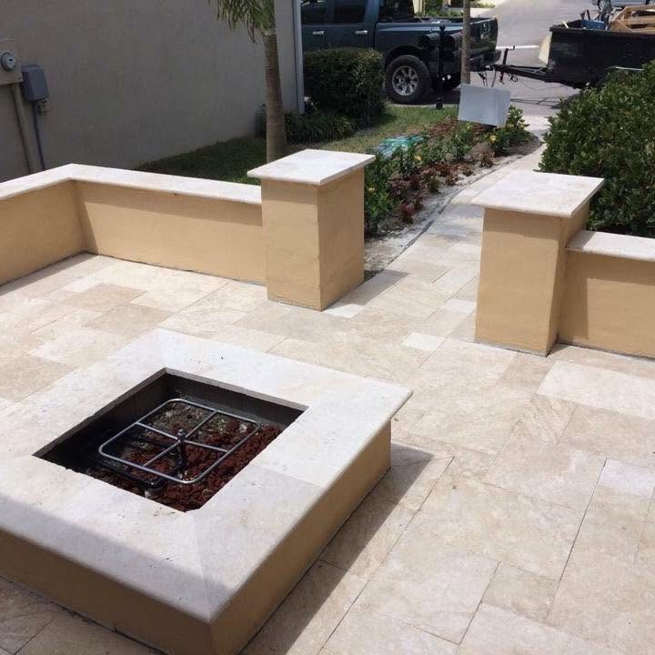 Travertine patio with built-in fire pit and seating columns