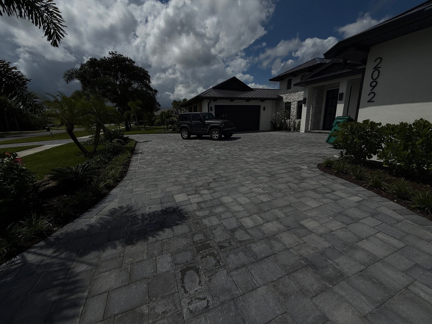 Curved paver driveway at a modern home