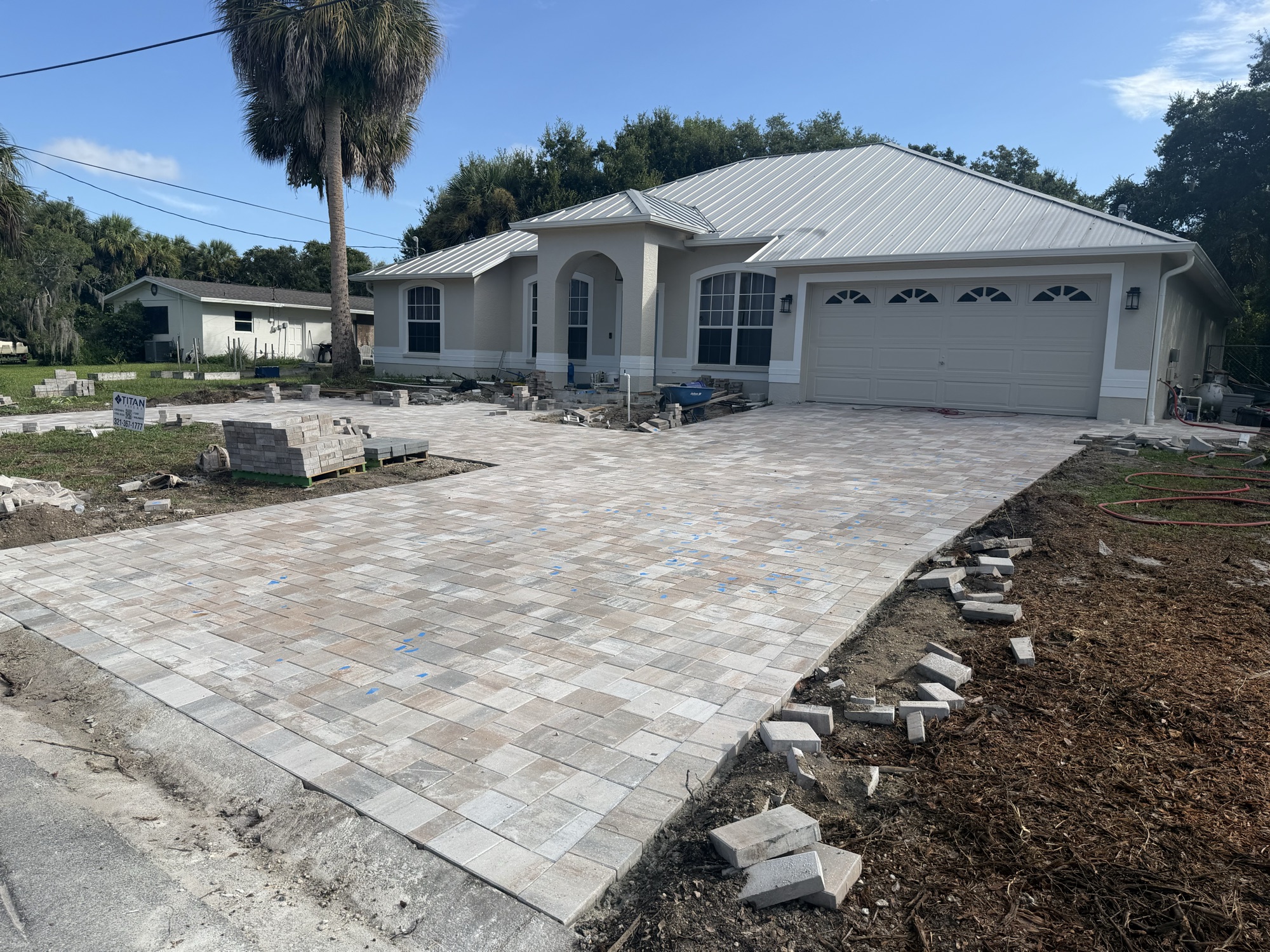 Sand-blend paver driveway being installed at a new-construction home