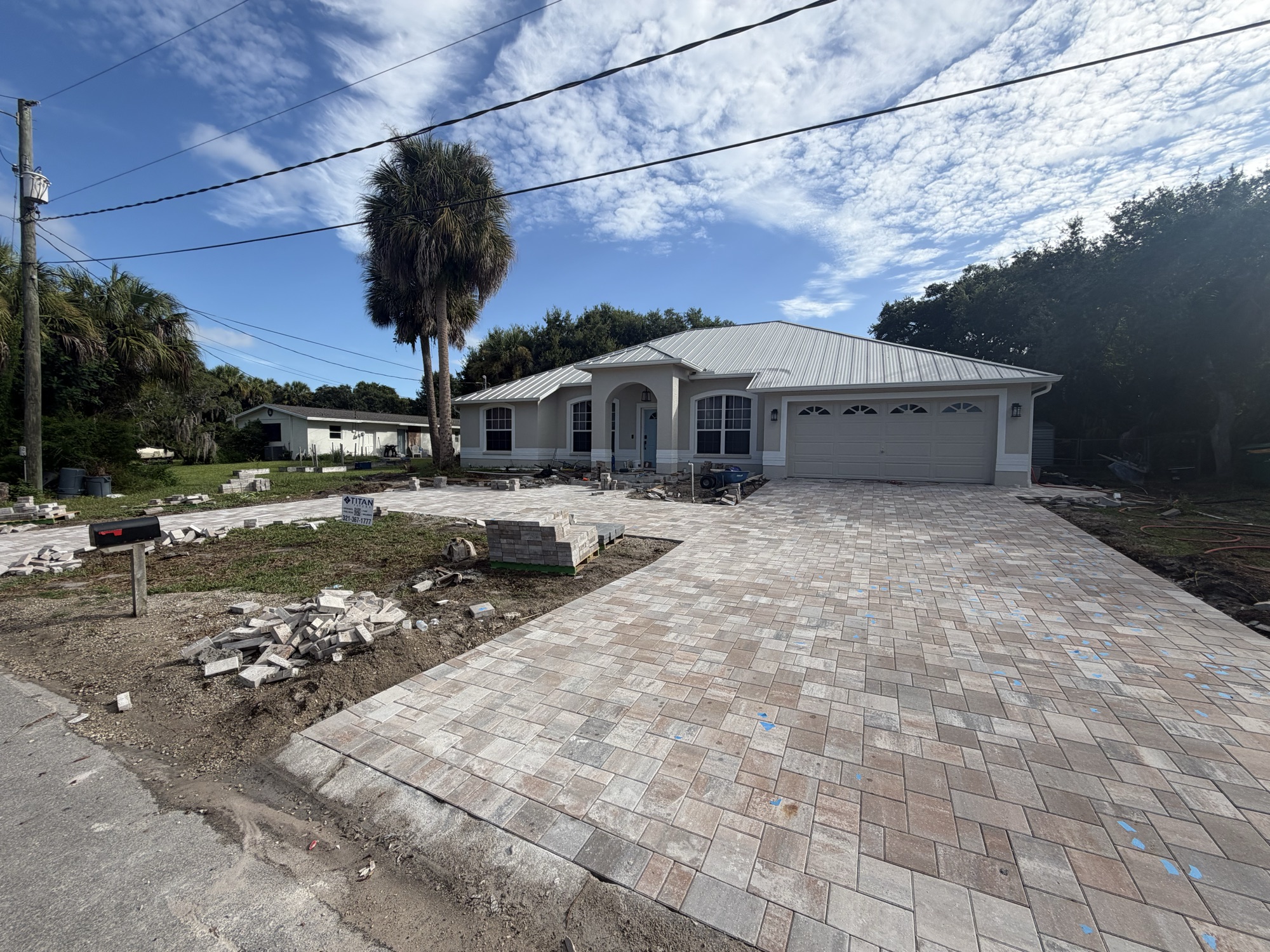 Paver driveway and walkway seen from the street with Titan yard sign