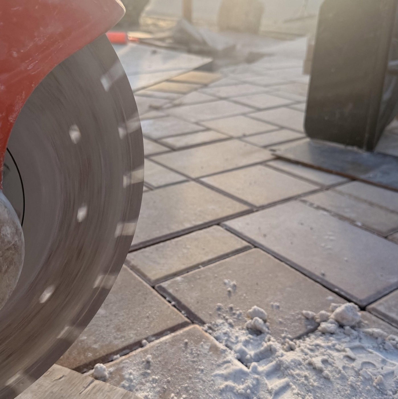 Cutting border pavers on site at golden hour